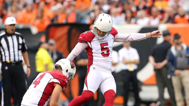 Arizona Cardinals punter Andy Lee (4) holds for kicker Zane Gonzalez (5) during the third quarter against the Cincinnati Bengals at Paul Brown Stadium.